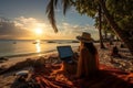 Beautiful woman in wide-brimmed hat typing on laptop at tropical beach with stunning ocean view