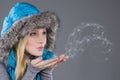 Beautiful Woman in Winter Clothes blowing