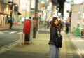 Woman in winter clothing walking at night in The Jozenji christmas light up festival in Sendai, Japan