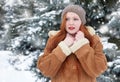 Beautiful woman on winter outdoor, snowy fir trees in forest, long red hair, wearing a sheepskin coat Royalty Free Stock Photo