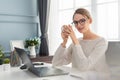 Beautiful woman working at home at the cozy living room Royalty Free Stock Photo