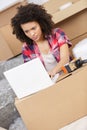 Beautiful woman working with laptop during office relocation