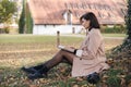 Beautiful woman working on laptop in the park. Attractive freelancer on outdoors. Royalty Free Stock Photo