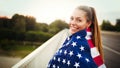 Beautiful woman wrapped in American flag Royalty Free Stock Photo