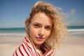 Beautiful woman wrapped in towel standing on the beach Royalty Free Stock Photo