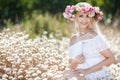 Beautiful woman with a wreath of flowers in summer field Royalty Free Stock Photo