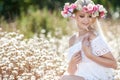 Beautiful woman with a wreath of flowers in summer field Royalty Free Stock Photo