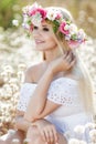 Beautiful woman with a wreath of flowers in summer field Royalty Free Stock Photo