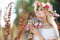 Beautiful woman with a wreath of flowers in summer field Royalty Free Stock Photo