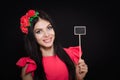 Beautiful woman with a wreath of red flowers holds a wooden plaque Royalty Free Stock Photo