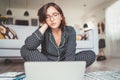 Beautiful woman writer dressed pajamas typing notebook keyboard writing novel sitting cross-legged on living room floor with a Royalty Free Stock Photo