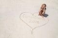 Beautiful woman writes on the sand on a Caribbean beach. Dominican Republic.Punta cana Royalty Free Stock Photo