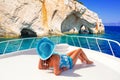 Beautiful woman on yacht cruise at the blue caves of Zakynthos island. Greece