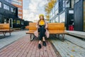 Beautiful woman in yellow beret sits on the street on the bench, depicts emotions. Summer time, yellow colors Royalty Free Stock Photo