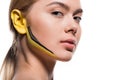 beautiful woman with yellow and black paints on ear and face Royalty Free Stock Photo