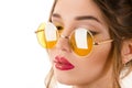 Beautiful woman in yellow round glasses close-up