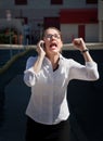 Beautiful woman yells into cell phone Royalty Free Stock Photo