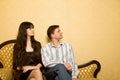 Beautiful woman and young man sitting on sofa Royalty Free Stock Photo