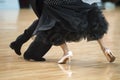Beautiful womanish and masculine legs in active ballroom dance,