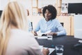 Beautiful womans making business meeting in modern office. Group of girls coworkers discussing together new fashion project. Royalty Free Stock Photo