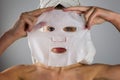 Beautiful women applying facial mask with moisturizer Royalty Free Stock Photo
