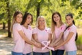 Beautiful women of different ages holding pink ribbon outdoors. Breast cancer concept Royalty Free Stock Photo