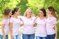 Beautiful women of different ages with pink ribbons outdoors. Breast cancer concept Royalty Free Stock Photo