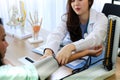 Beautiful woman Doctor checking a patients blood pressure. Royalty Free Stock Photo