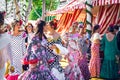 Beautiful women dressed in traditional costumes enjoy April Fair , Seville Fair Feria de Sevilla Royalty Free Stock Photo