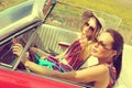 Beautiful women driving a red car retro vintage wearing accesoriess Royalty Free Stock Photo