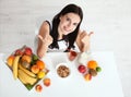 Beautiful women exists with pure skin on her face sitting at a table and eat breakfast. Asian woman eating healthy food at Royalty Free Stock Photo