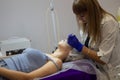 Beautician makes facial massage to a woman