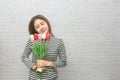 Beautiful women with flowers tulips in hands on a light background Royalty Free Stock Photo