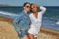 Beautiful women friends enjoy a walk on the beach on a Sunny day. Royalty Free Stock Photo