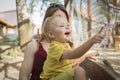 Beautiful woman mother holding her happy boy son,smiling showing on an animal in a cage in the zoo Royalty Free Stock Photo