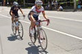 Beautiful women riding bicycles in a sunny day, competing for Road Grand Prix event, a high-speed circuit race in