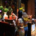 Asian women lighting candles in Buddhist and Taoist Temple Jade Emperor Pagoda, Ho Chi Minh City, Vietnam. Royalty Free Stock Photo