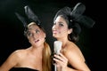 Beautiful women singing on a vintage microphone Royalty Free Stock Photo