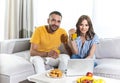 Cute couple is sitting on couch at home Royalty Free Stock Photo