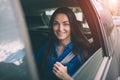 Beautiful woman smiling while sitting on back seat in the car Royalty Free Stock Photo