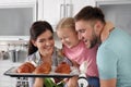 Beautiful woman treating her family with freshly oven baked buns