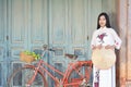 Beautiful women Vietnam with white Ao Dai dress and red bicycle in old city Royalty Free Stock Photo