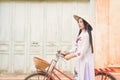 Beautiful women Vietnam with white Ao Dai dress and red bicycle