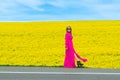 Beautiful women walking in amazing field of yellow rapeseed in the countryside. Canola oil plants Royalty Free Stock Photo