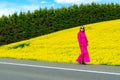 Beautiful women walking in amazing field of yellow rapeseed in the countryside. Canola oil plants Royalty Free Stock Photo