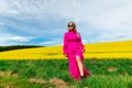 Beautiful women walking in amazing field of yellow rapeseed in the countryside. Canola oil plants Royalty Free Stock Photo