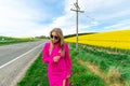 Beautiful women walking in amazing field of yellow rapeseed in the countryside. Canola oil plants Royalty Free Stock Photo