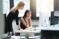 Beautiful women working together in the office on a computer Royalty Free Stock Photo