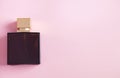 Beautiful womens perfume isolaed on a pink background