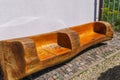 A beautiful wooden bench made of a piece of wood Royalty Free Stock Photo